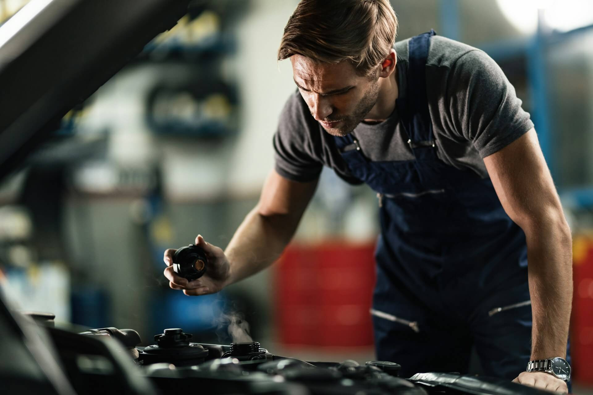 a certified mechanic checking a salvage car