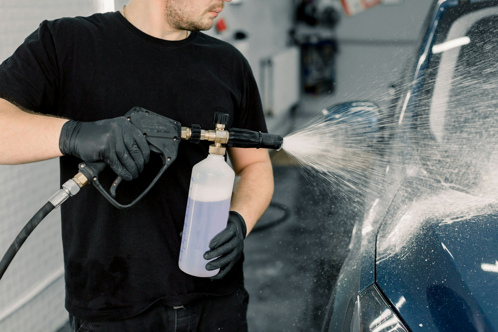 man washing and polishing a car