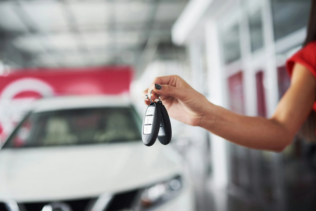 a driver is handed the keys to the new car