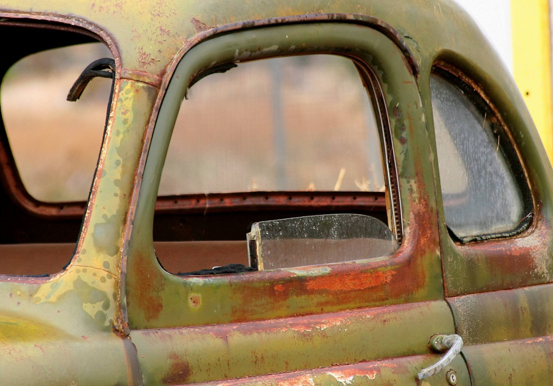 a junk car with broken windows
