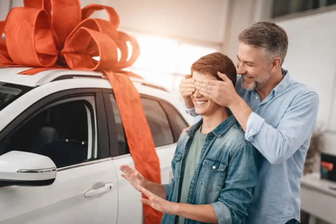 father surprising his teenage son with a car gift
