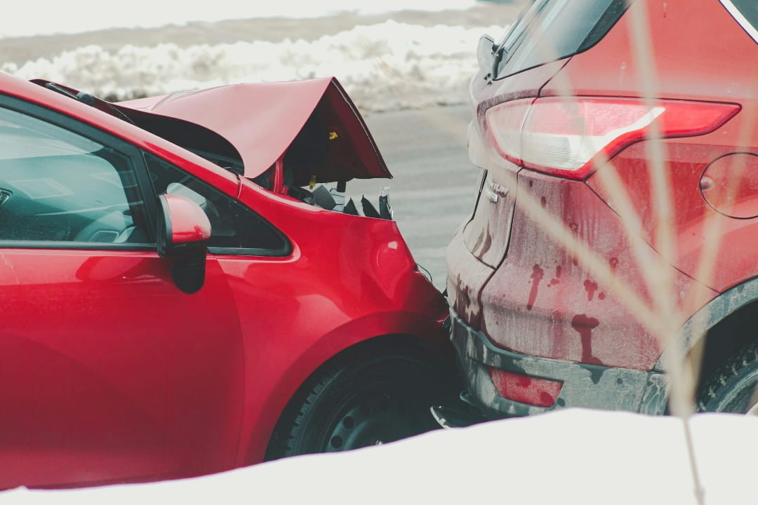 two vehicles involved in a rear-end collision on a snowy road